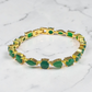 krivoya Ankita tennis bracelet featuring alternating round and pear-cut green stones set in polished gold-tone metal