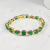 krivoya Ankita tennis bracelet featuring gold-tone metal and alternating pear and round green stones