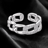 krivoya 92.5 sterling silver chain link ring with sparkling cubic zirconia stones on a black satin background