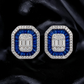 krivoya 92.5 sterling silver earrings featuring baguette-cut blue sapphires and clear crystals on black silk fabric.