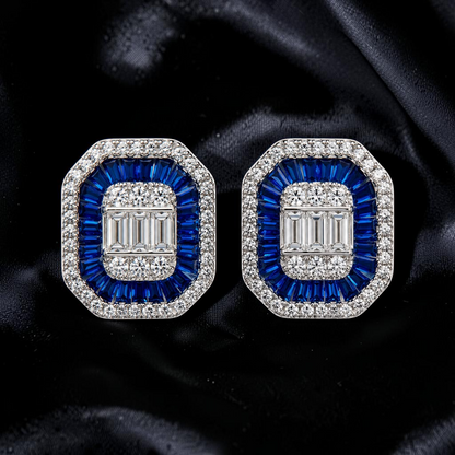 krivoya 92.5 sterling silver earrings featuring baguette-cut blue sapphires and clear crystals on black silk fabric.